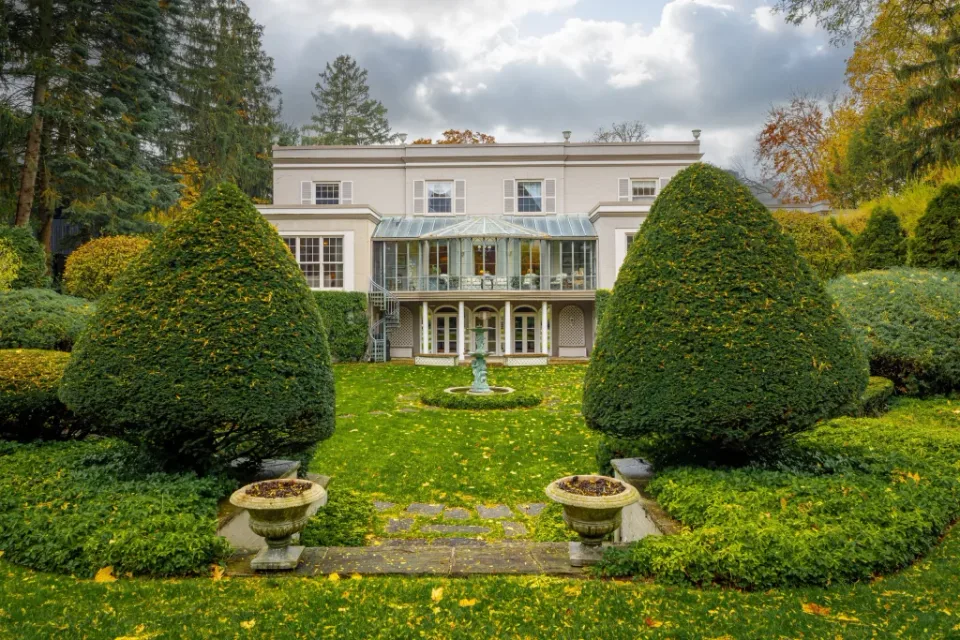 Luxury real estate photograph of an elegant estate exterior with manicured gardens in London, Ontario.