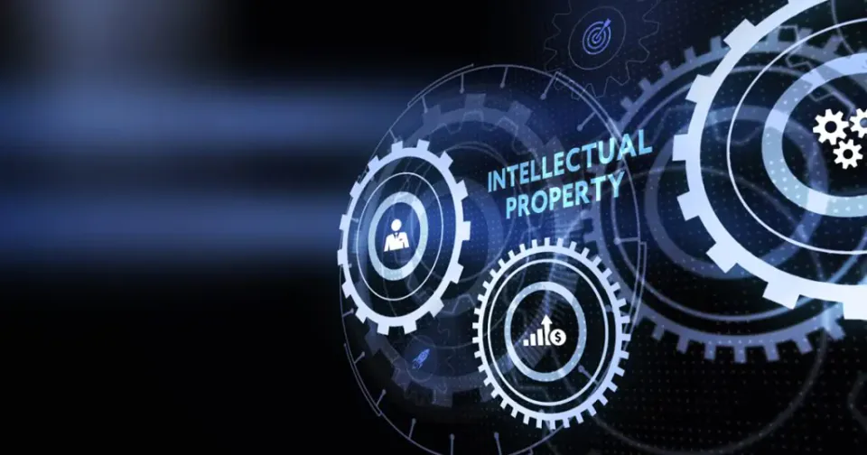 Digital graphic of interconnected gears with icons and the words “Intellectual Property” in white text, symbolizing technology and intellectual property concepts on a dark background.