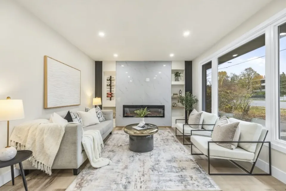 Contemporary living room interior with marble accent wall, neutral décor, and natural lighting ,  captured by MPV | Mike Popovici Visuals in London Ontario.