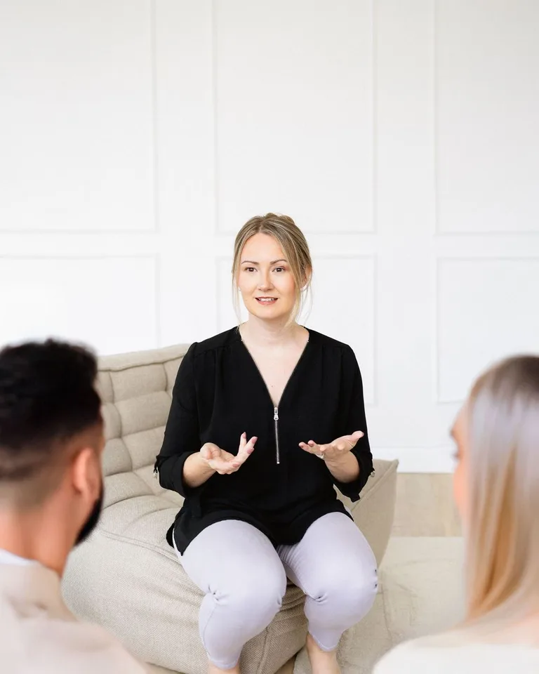 Nichole Cook therapist sitting during a session with a couple clients.