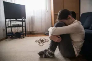 Pre-teen huddled on the floor refusing to see access parent.
