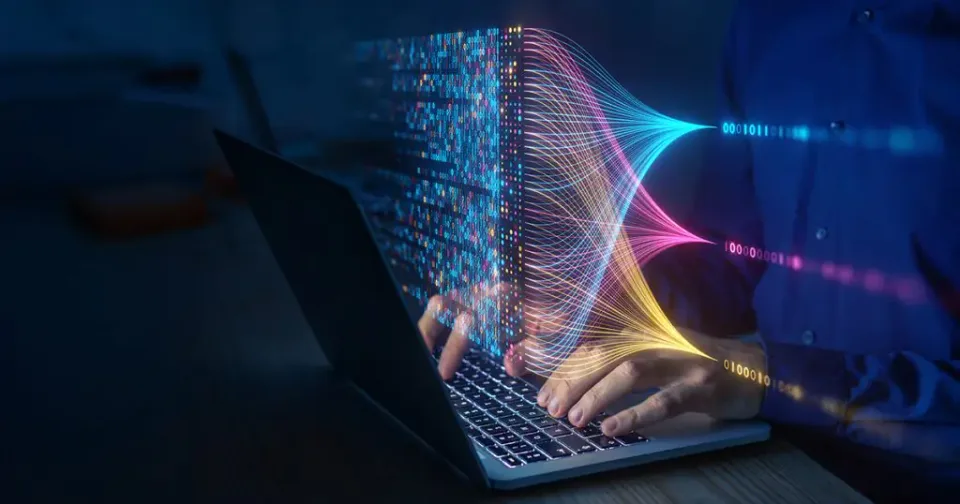 Person typing on a laptop with abstract digital lines and data streams emerging from the screen, representing artificial intelligence.