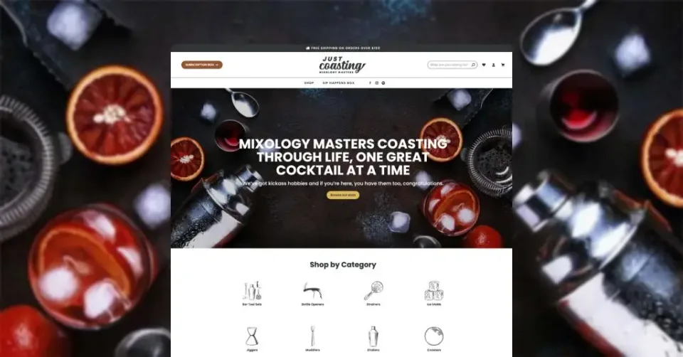 A cocktail-themed barware ecommerce website design homepage featuring cocktail ingredients, a shaker, and sliced citrus fruits, with the headline “Mixology masters coasting through life, one great cocktail at a time.”.