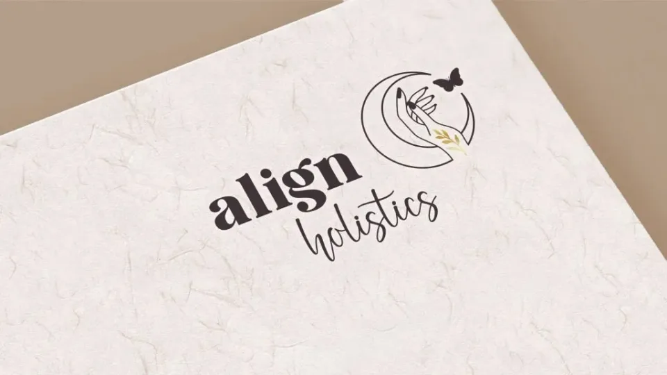 A minimalist logo features the words align holistics with a hand reaching towards a butterfly inside a crescent shape, perfect for an energy healing website design, all set on a light textured background.