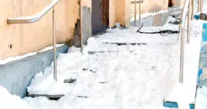 Snowy and slippery stairs on a porch.