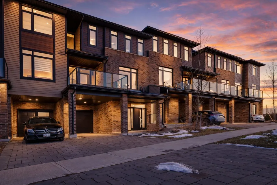 Row of modern townhomes on Sheffield Blvd in London, Ontario, captured at sunset with light trails along the road – real estate architecture photo by MPV (Mike Popovici Visuals).