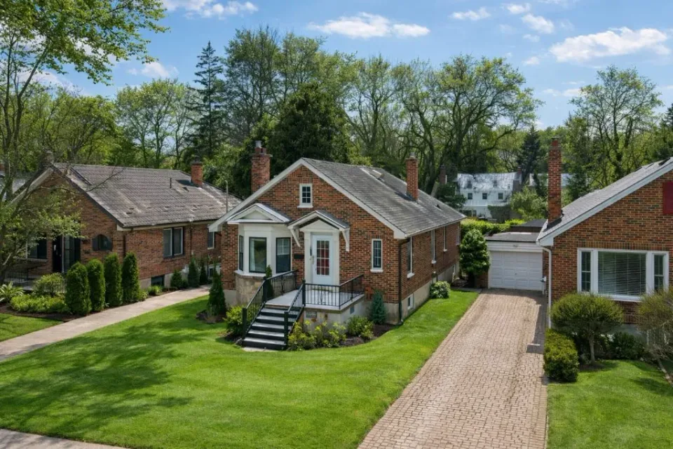 Drone photography for real estate in London, Ontario showing a detached home in summer, captured from an aerial perspective to highlight green landscaping, property layout, driveway, and surrounding neighborhood.