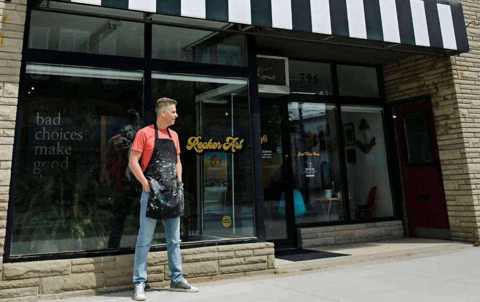 Jason Recker standing in front of his art studio and gallery